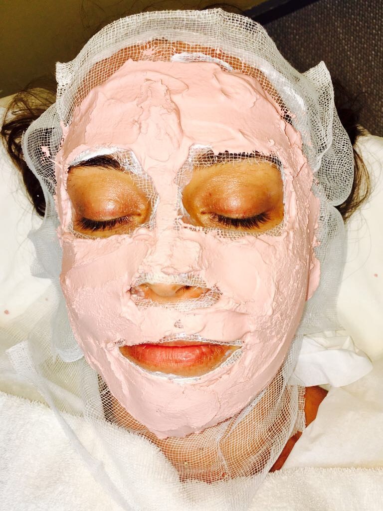 Woman receiving thermo heating mask for deep cleansing facial 